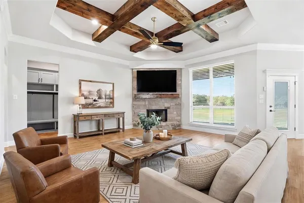 a living room with furniture a fireplace and a flat screen tv