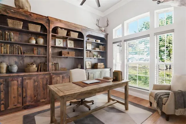 a view of a workspace with furniture and a bookshelf