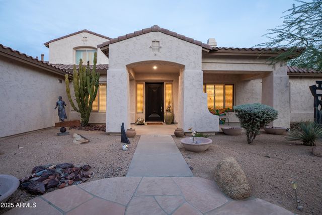 a kitchen with stainless steel appliances granite countertop a stove a sink a microwave a dining table and chairs