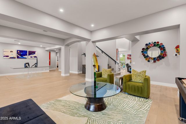 a view of a patio with chairs and potted plants