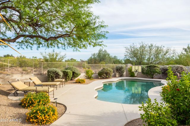 an aerial view of a house with a yard and lake view