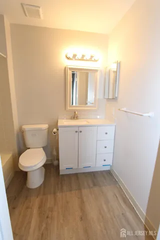 a bathroom with a toilet sink and mirror