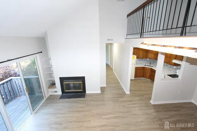 a view of living room with furniture and a fireplace