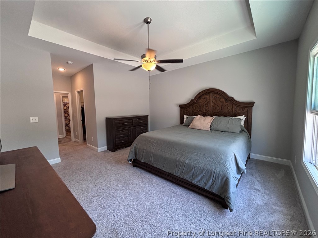 7720 Rufus Johnson Road Fayetteville, NC 28306 - Photo 44 of 50 a bedroom with a bed ceiling fan and a rug