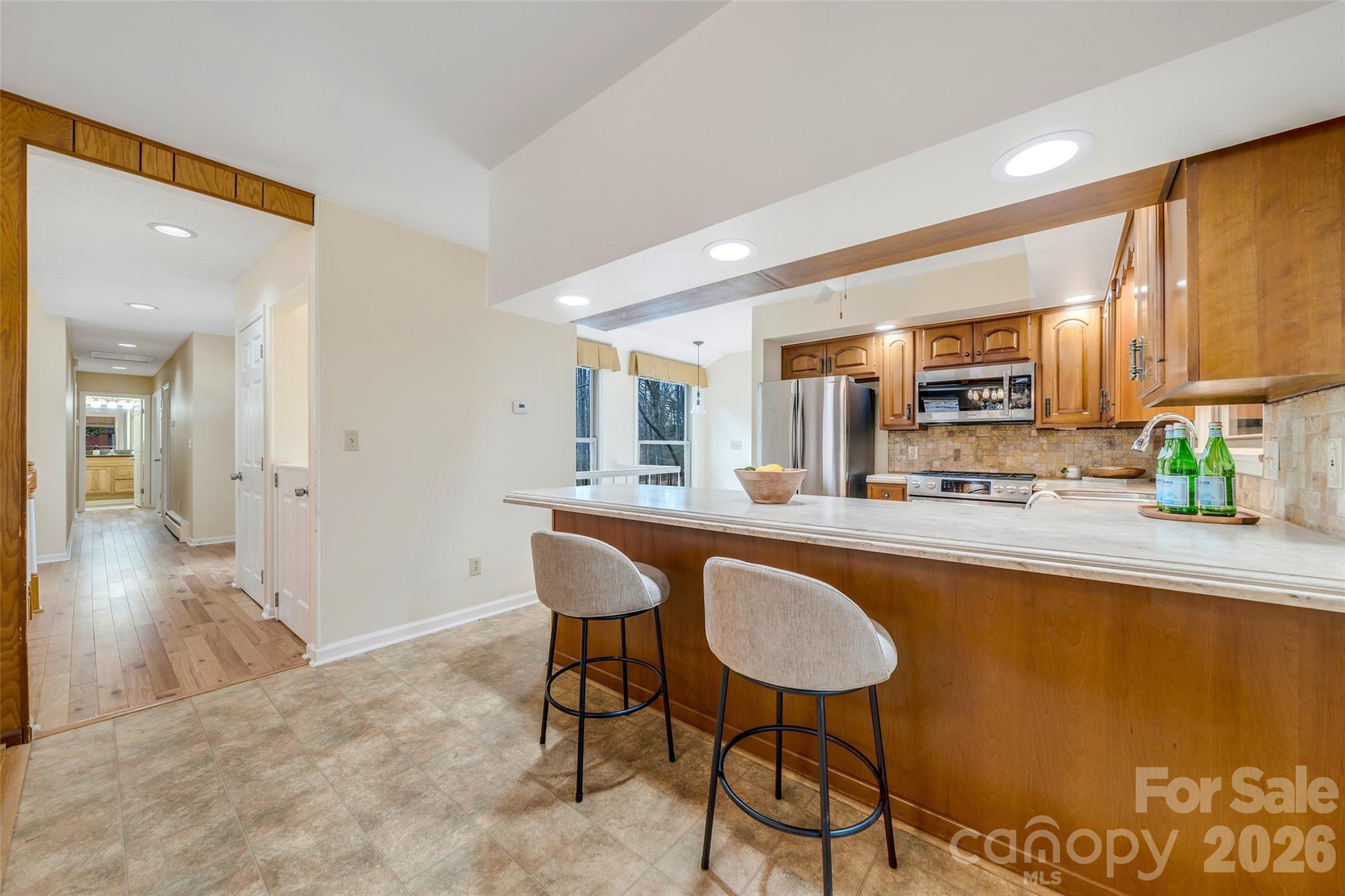 63 Pinecroft Road Asheville, NC 28804 - Photo 15 of 48 a kitchen with stainless steel appliances granite countertop a sink and a refrigerator