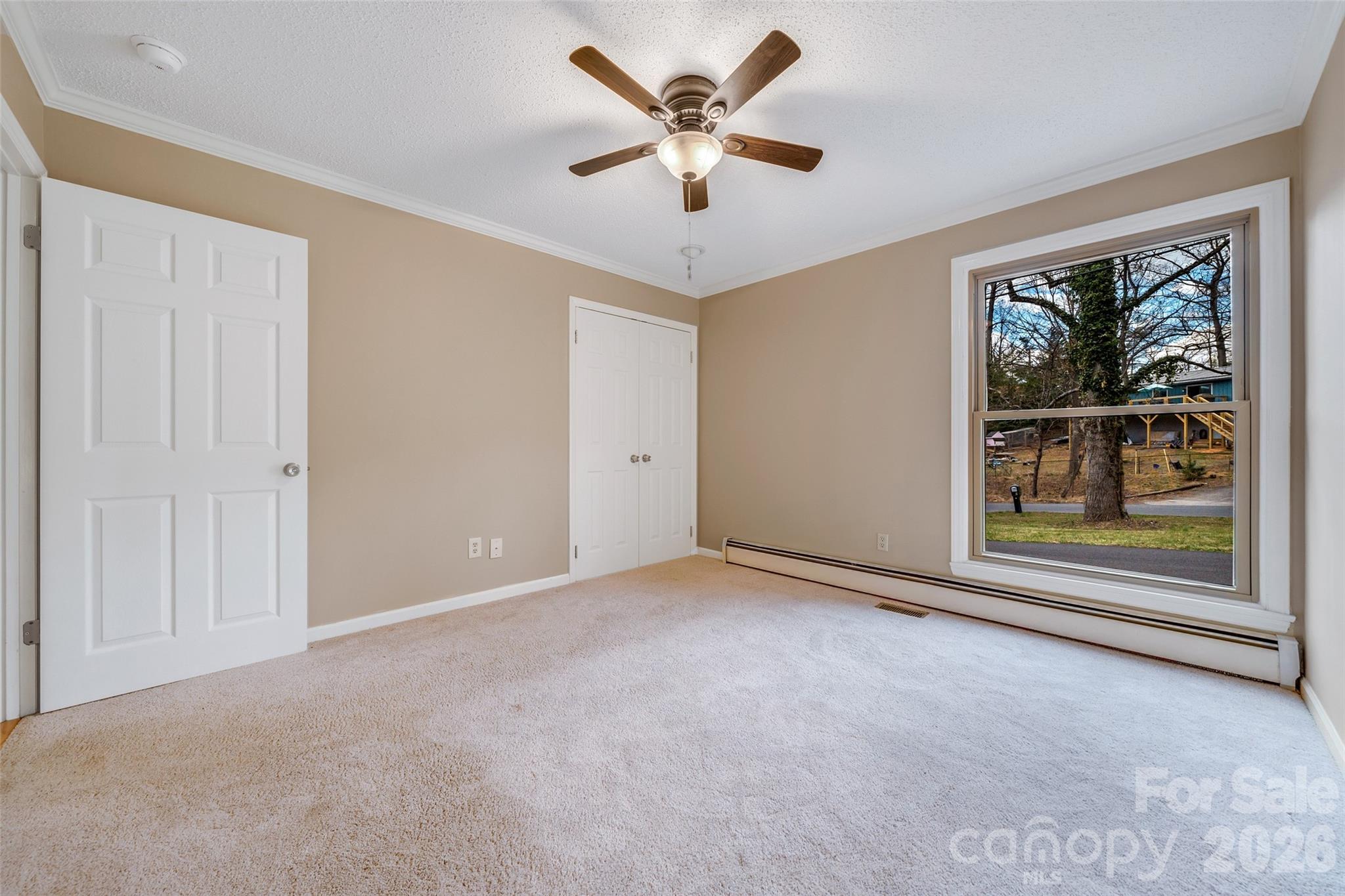 63 Pinecroft Road Asheville, NC 28804 - Photo 38 of 48 an empty room with window and ceiling fan