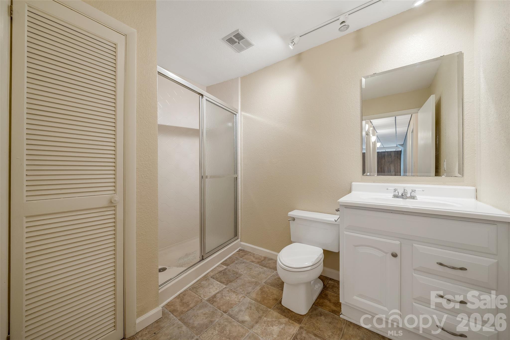 63 Pinecroft Road Asheville, NC 28804 - Photo 46 of 48 a bathroom with a toilet sink and shower