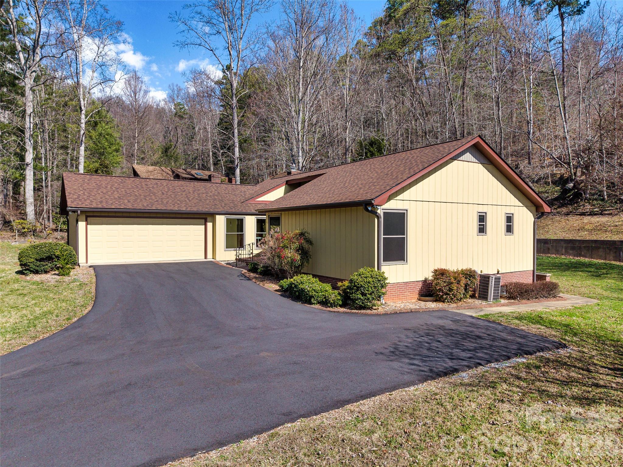 63 Pinecroft Road Asheville, NC 28804 - Photo 5 of 48 a front view of a house with a yard and garage