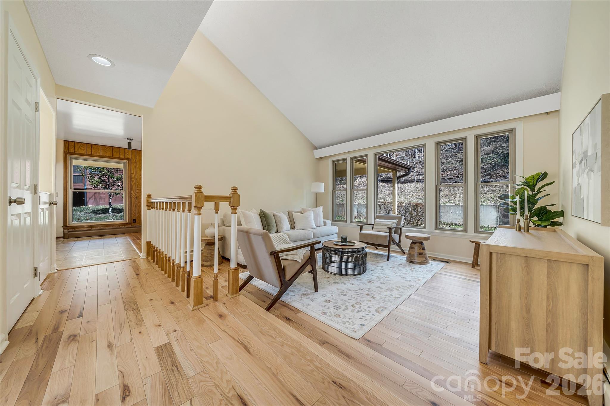 63 Pinecroft Road Asheville, NC 28804 - Photo 8 of 48 a living room with furniture and large windows