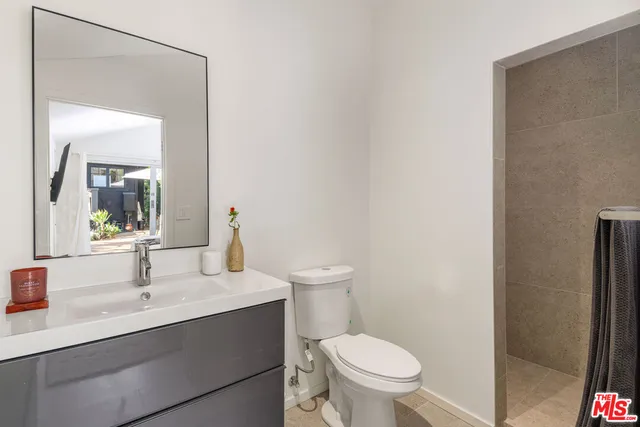 a bathroom with a sink toilet and a mirror