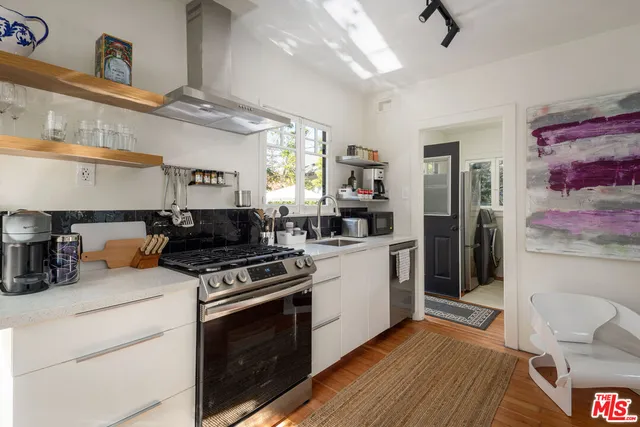 a kitchen with stainless steel appliances granite countertop a stove and a sink
