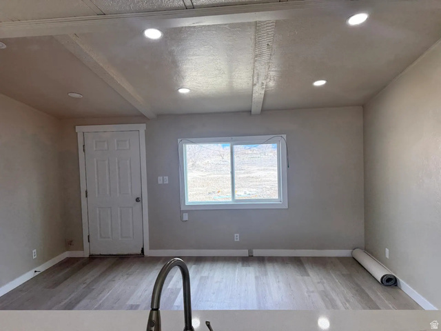 446 Riverside Drive, Unit 24 Wellington, UT 84542 - Photo 3 of 14 Entryway featuring light wood-type flooring, beamed ceiling, and recessed lighting