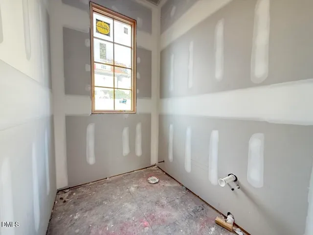 a living room with furniture a large window and gym equipment