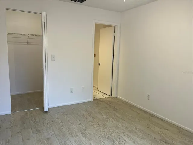 an empty room with closet area