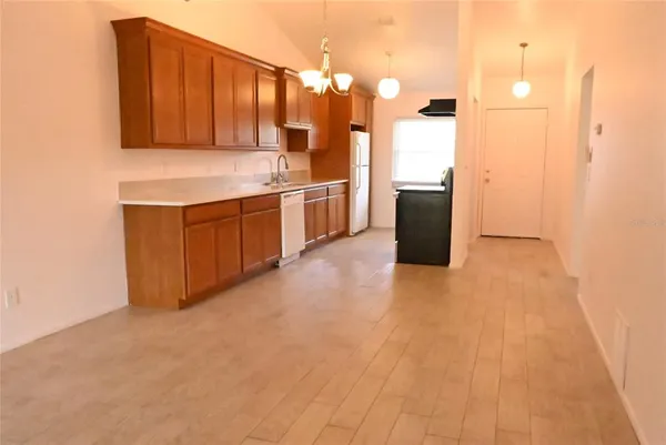 a kitchen with a sink cabinets and wooden floor