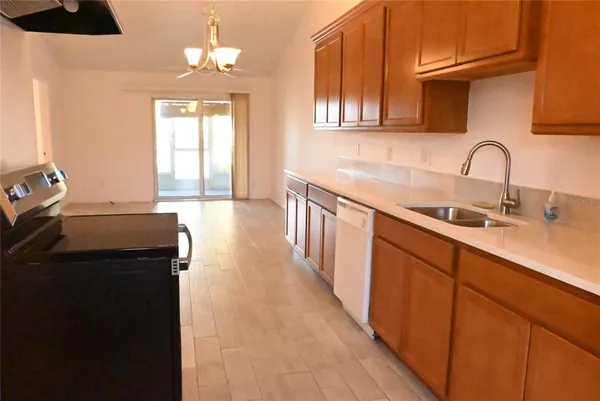 a kitchen with sink a refrigerator and cabinets
