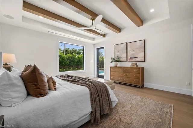 a spacious bedroom with a bed and a large window