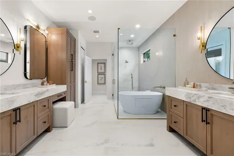 a en suite bathroom with a double vanity sink and a mirror