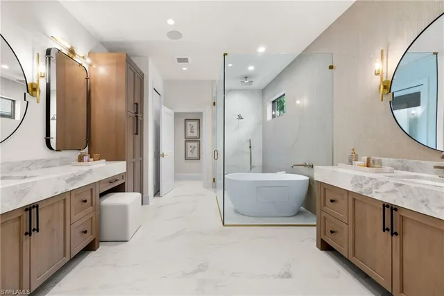 a en suite bathroom with a double vanity sink and a mirror