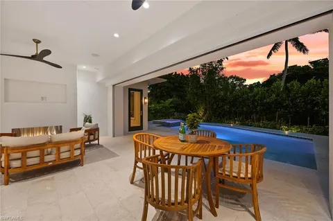 a dining room with furniture and wooden floor