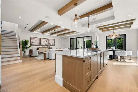 a kitchen with a sink a stove a refrigerator and cabinets