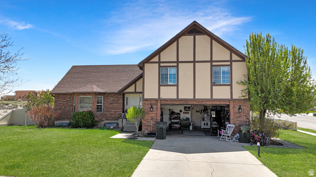 1716 Sagewood Road Price, UT 84501 - Photo 64 of 73 Tudor-style house with brick siding, a front lawn, driveway, and stucco siding