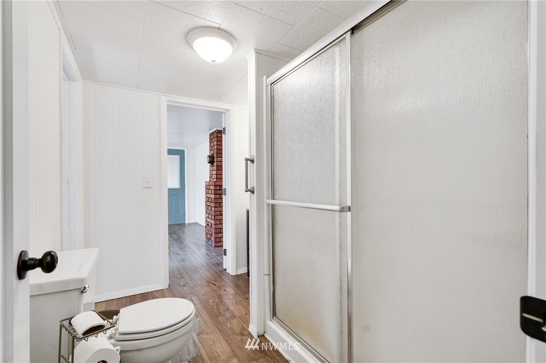 14019 Chain Lake Road Monroe, WA 98272 - Photo 17 of 32 a bathroom with a granite countertop toilet a sink and a mirror