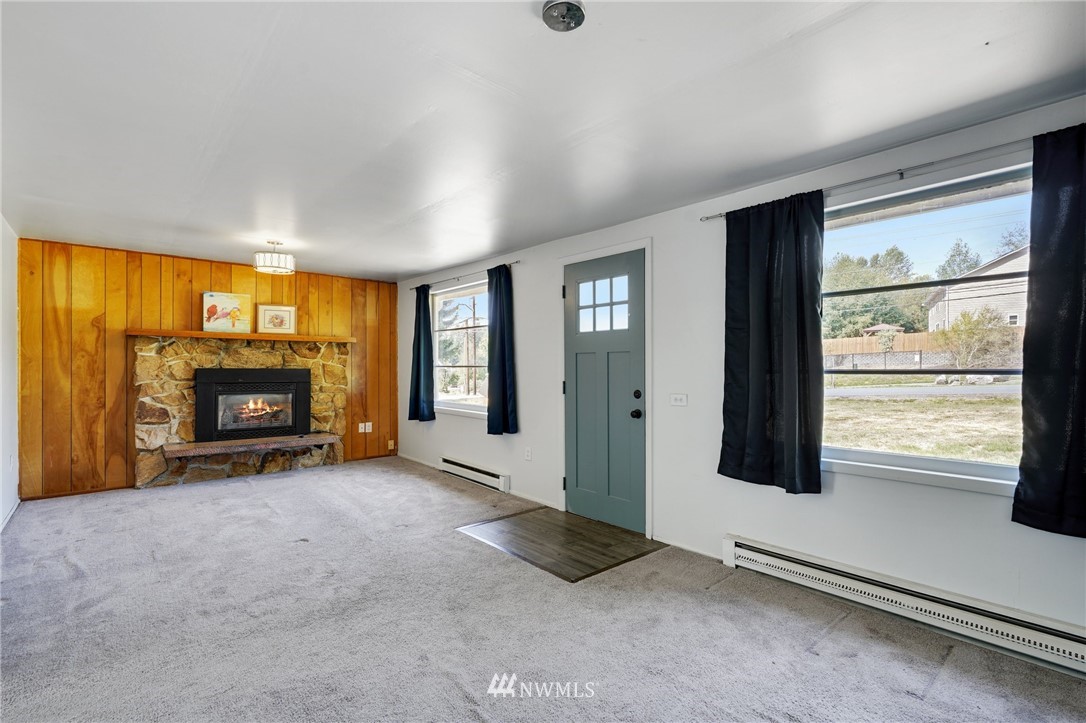 14019 Chain Lake Road Monroe, WA 98272 - Photo 3 of 32 an empty room with furniture and a fireplace
