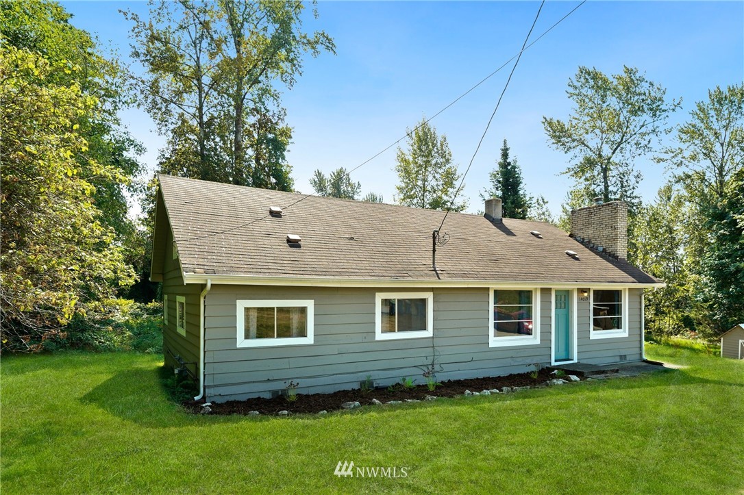 14019 Chain Lake Road Monroe, WA 98272 - Photo 23 of 32 a front view of a house with a garden