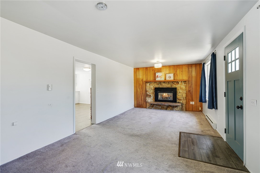 14019 Chain Lake Road Monroe, WA 98272 - Photo 4 of 32 a view of a windows and a fireplace in a room