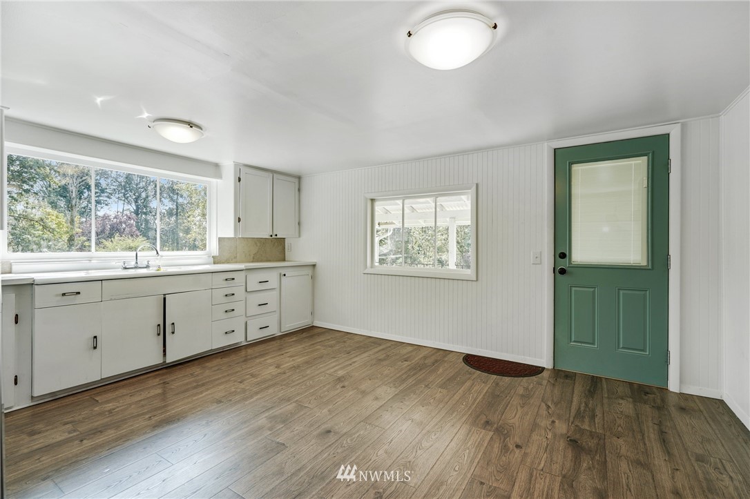 14019 Chain Lake Road Monroe, WA 98272 - Photo 5 of 32 a view of a kitchen with wooden floor and windows
