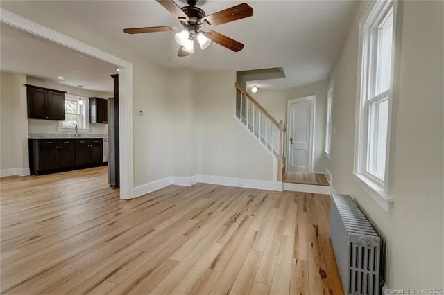 wooden floor in an empty room with a window