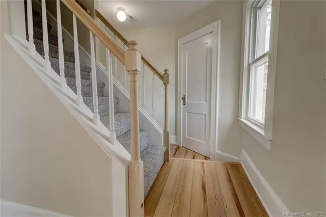 a view of an entryway with wooden floor