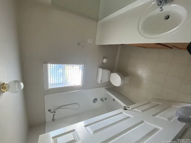 a view of washer and dryer with wooden floor