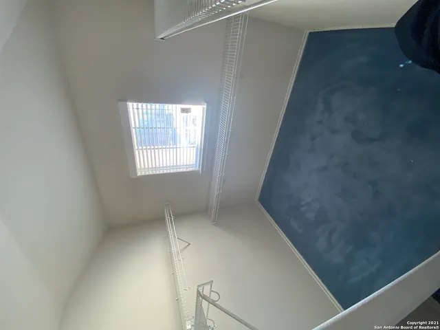 a view of backyard with wooden fence