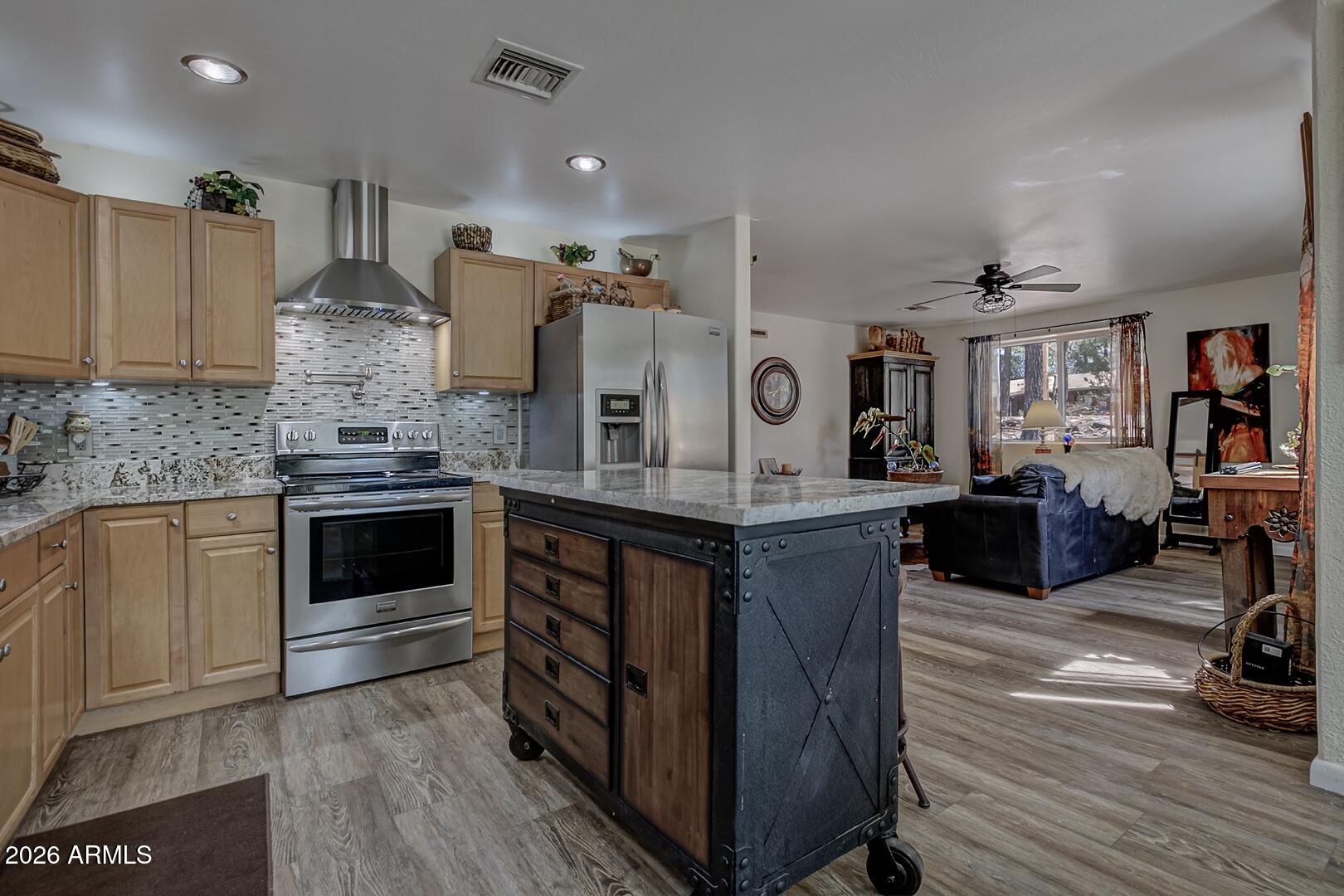 3762 Watertank Road Pine, AZ 85544 - Photo 9 of 38 a kitchen with stainless steel appliances granite countertop a stove and a sink