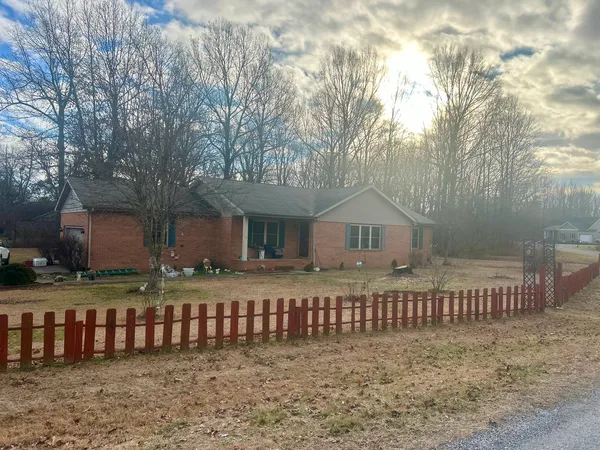 a front view of a house with a fence