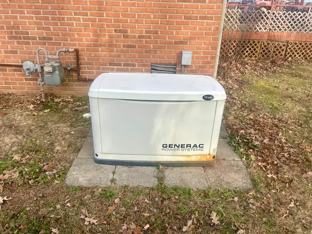 a backyard of a house with large trees and outdoor seating