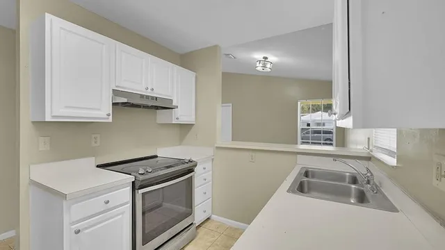 a kitchen that has a sink and a stove