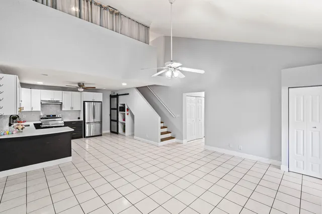 a kitchen with stainless steel appliances granite countertop a stove and a refrigerator
