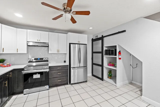a kitchen with a sink a stove and cabinets