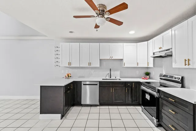 a kitchen with a sink cabinets and window