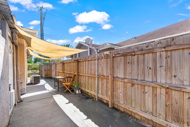 a view of a patio with table and chairs