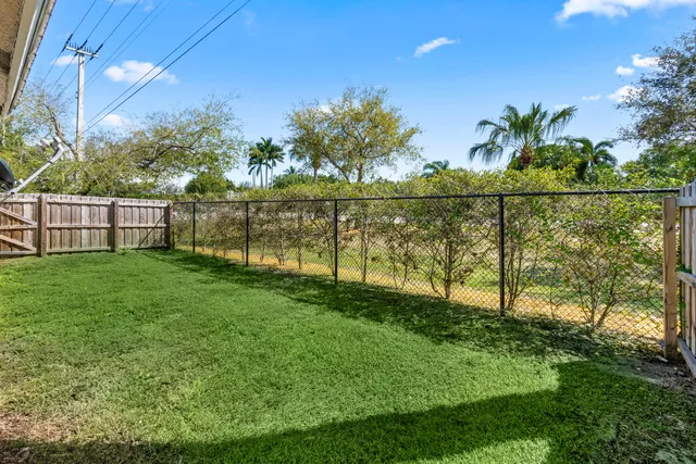 a view of a house with a yard and deck