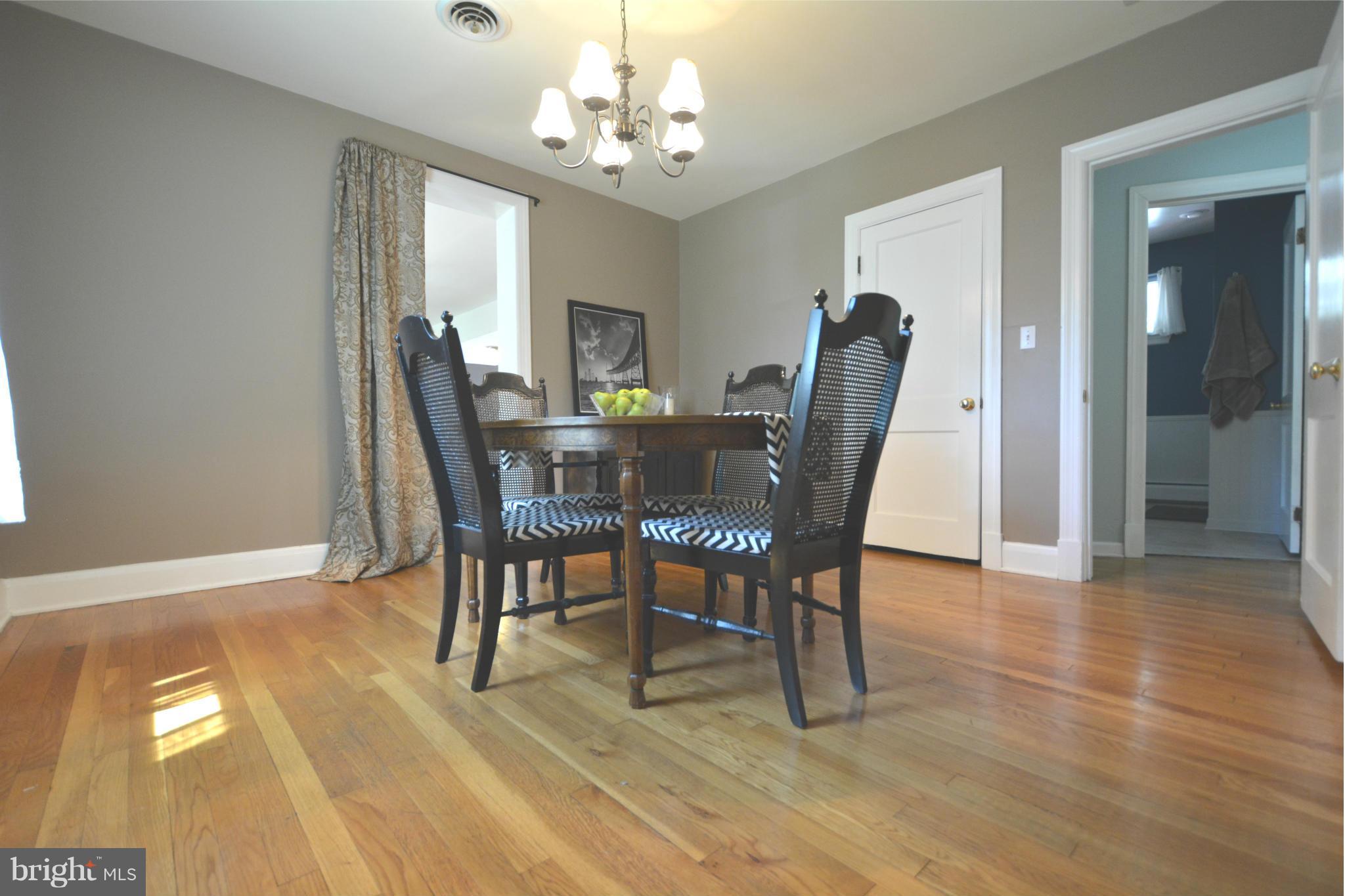 5911 Medora Road Linthicum, MD 21090 - Photo 14 of 30 a view of a dining room with furniture and chandelier