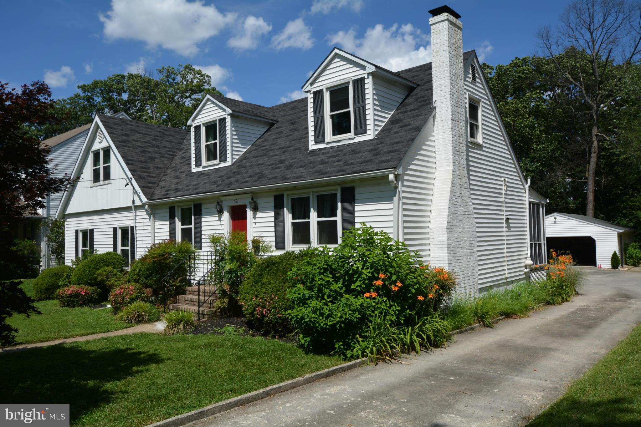 5911 Medora Road Linthicum, MD 21090 - Photo 3 of 30 a front view of a house with a yard and potted plants