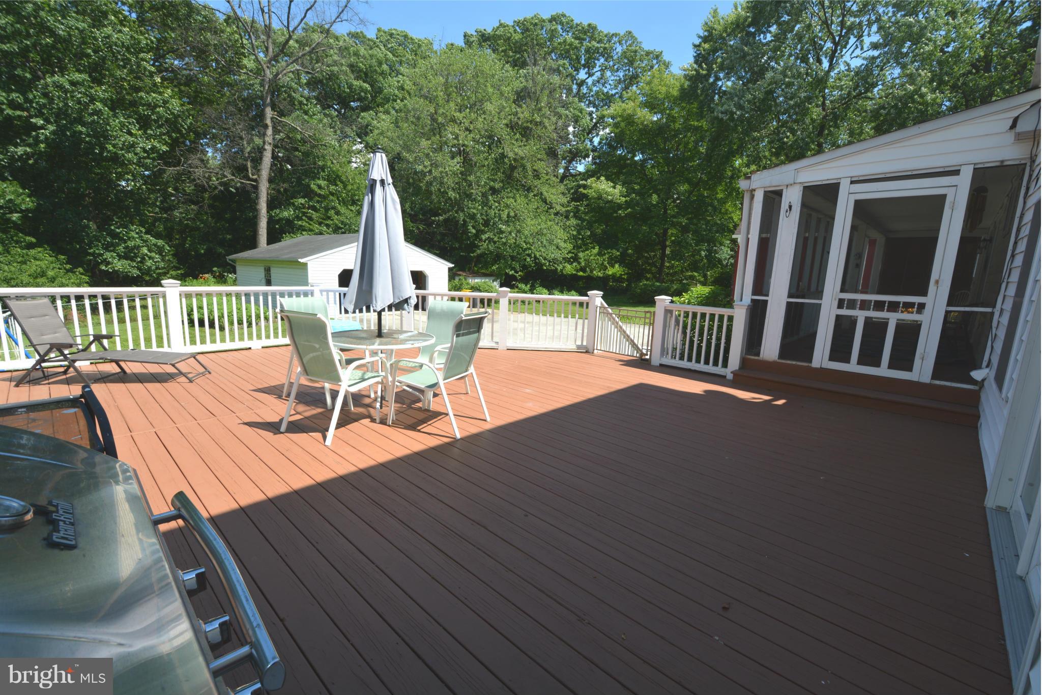 5911 Medora Road Linthicum, MD 21090 - Photo 22 of 30 a view of a patio with a table chairs and a wooden deck