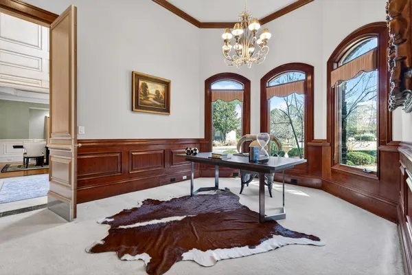 a kitchen with stainless steel appliances kitchen island granite countertop a refrigerator a stove a sink and a dining table with wooden cabinets