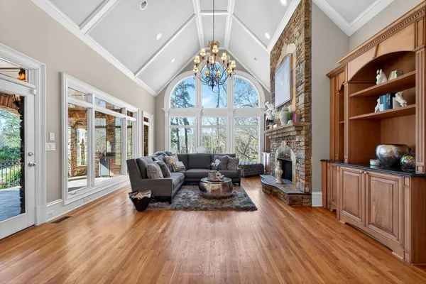 a kitchen with a stove and a white wooden cabinets