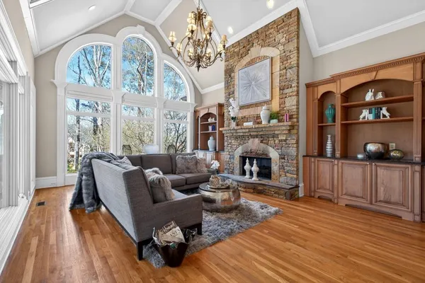 a kitchen with stainless steel appliances granite countertop a stove a sink a dining table and chairs